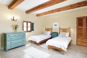 una camera con due letti e un comò blu di Dar ta' Censina Villa with Private Pool a Għasri Altre 17 foto