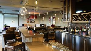 a bar in a restaurant with a counter and chairs at Hilton Garden Inn Arvada/Denver, CO in Arvada