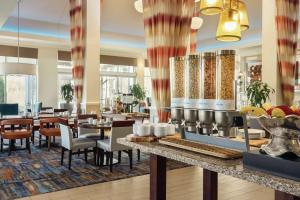 a dining room with tables and chairs and a restaurant at Hilton Garden Inn Bridgewater in Bridgewater