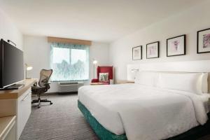 a hotel room with a bed and a flat screen tv at Hilton Garden Inn Bridgewater in Bridgewater