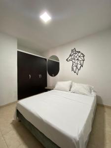 ein Schlafzimmer mit einem großen Bett und einem schwarzen Schrank in der Unterkunft apto caney 301 in Cali