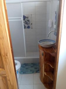 a bathroom with a sink and a toilet at Relic's mini Resort in Puerto Cayo