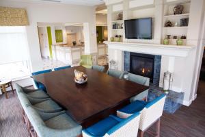 a dining room with a table and a fireplace at Hilton Garden Inn Gettysburg in Gettysburg