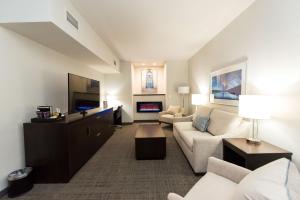 a living room with a couch and a tv at Hilton Scranton & Conference Center in Scranton