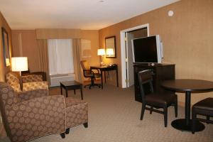 a hotel room with a couch and a tv and a living room at Hampton Inn and Suites Barstow in Barstow