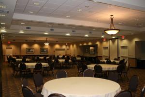 a banquet hall with white tables and chairs at Hampton Inn and Suites Barstow in Barstow