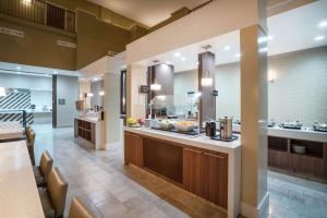 a large kitchen with a counter and a cafeteria at Embassy Suites Nashville - at Vanderbilt in Nashville