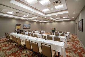 a conference room with white tables and chairs in it at Embassy Suites Nashville - at Vanderbilt in Nashville +26 photos