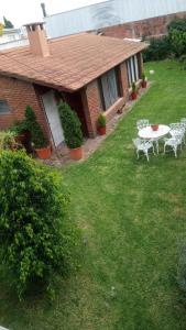 un patio con mesa y sillas frente a una casa en remanso en Mar del Plata