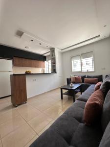 a living room with a couch and a kitchen at chez mehdi in Skhirat