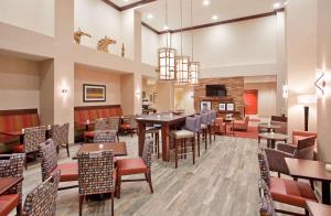 a dining room with tables and chairs in a restaurant at Hampton Inn & Suites Omaha Southwest-La Vista in La Vista