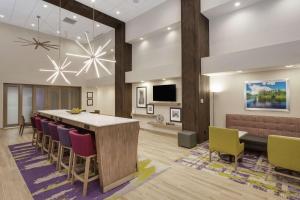 a lobby with a long table and chairs at Hampton Inn & Suites Rocky Hill - Hartford South in Rocky Hill