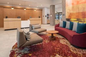 a lobby with two couches and a table and a counter at Homewood Suites By Hilton Belmont in Belmont
