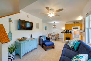 a living room with a blue couch and a table at Pet-Friendly Buxton Vacation Rental Near Ocean! in Buxton