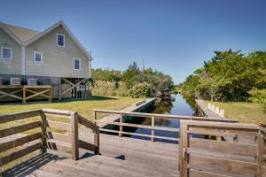 a house and a wooden bridge over a canal at Pet-Friendly Buxton Vacation Rental Near Ocean! in Buxton