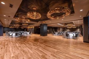 a ballroom with tables and chairs and chandeliers at Hilton Garden Inn Pittsburgh Downtown in Pittsburgh