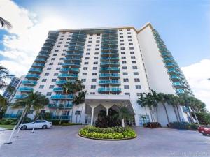 邁阿密海灘的住宿－Sunny Isles Miami HOLIDAY apartment，一座大型建筑,前面有停车位
