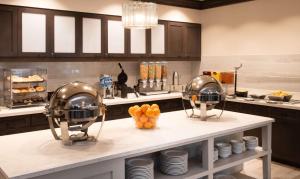 a kitchen with two football helmets on a counter at Homewood Suites By Hilton North Charleston in Charleston