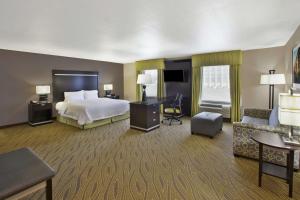 a hotel room with a bed and a desk at Hampton Inn & Suites - Elyria in Elyria