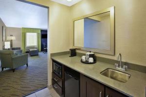 a hotel room with a sink and a living room at Hampton Inn & Suites - Elyria in Elyria