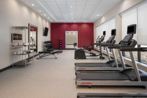 a gym with cardio equipment and a red wall at Home2 Suites By Hilton Carlsbad New Mexico in Carlsbad