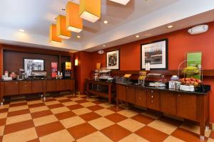 a lobby of a hotel with a cashier in a restaurant at Hampton Inn Yorkville in Yorkville