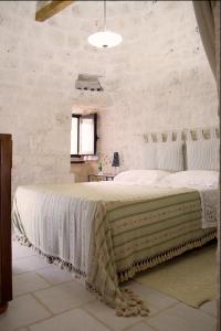 A bed or beds in a room at Trulli Sarmenzanello