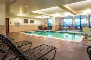 a large swimming pool with chairs in a building at Hilton Garden Inn Uniontown in Uniontown