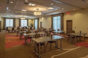 a large room with tables and chairs in it at Hilton Garden Inn Uniontown in Uniontown
