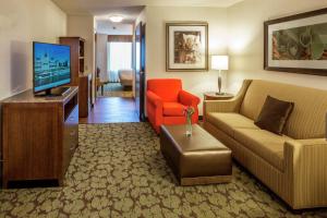 a living room with a couch and a television at Hilton Garden Inn Uniontown in Uniontown