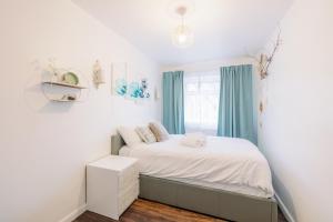 a small bedroom with a bed and a window at Home near Excel, Stratford and Canary Wharf in London