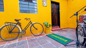 a bike parked in front of a yellow building at Mico Loco Casa Hostal in Bogotá