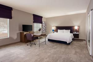 a hotel room with a bed and a desk and a television at Hampton Inn & Suites Leavenworth in Leavenworth +26 photos