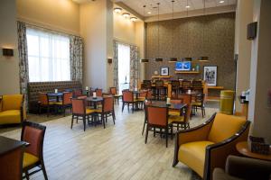 a dining room with tables and chairs in a restaurant at Hampton Inn & Suites Grenada in Grenada