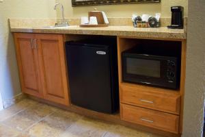 a kitchen with a sink and a black microwave at Hampton Inn & Suites Grenada in Grenada