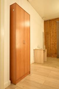 a large wooden cabinet in a room with a counter at Max Royal in Almaty