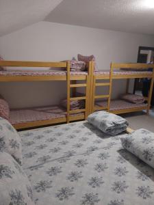 a bedroom with two bunk beds and a bed at Restoran BMB in Odžak
