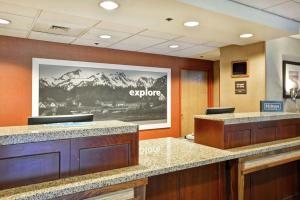 a hotel lobby with a sign that says explore at Hampton Inn Seattle/Southcenter in Tukwila