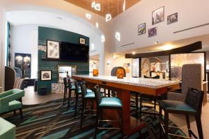 a bar in a restaurant with chairs around it at Hampton Inn & Suites Herndon-Reston in Herndon