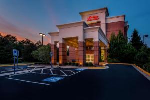 a store front of a hotel with a parking lot at Hampton Inn & Suites Herndon-Reston in Herndon
