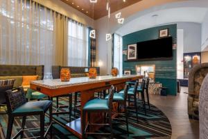 a bar in a restaurant with chairs and a television at Hampton Inn & Suites Herndon-Reston in Herndon