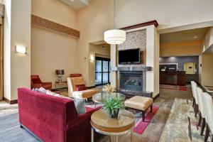 a living room with a couch and a fireplace at Hampton Inn and Suites Peoria at Grand Prairie in Peoria