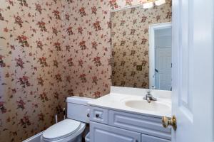 a bathroom with a toilet and a sink at 2873 Hidden Oak Drive in Seabrook Island