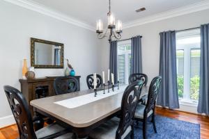 a dining room with a table and chairs and a mirror at 2873 Hidden Oak Drive in Seabrook Island +38 photos