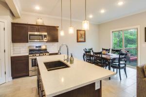 a kitchen and dining room with a table and chairs at Parkville Vacation Rental Near Creekside Complex! in Lansing