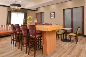 a bar in a room with chairs and a table at Hampton Inn Van Horn in Van Horn