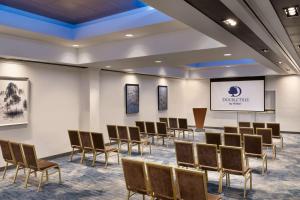 a conference room with chairs and a projection screen at DoubleTree by Hilton San Francisco South Airport Blvd in South San Francisco