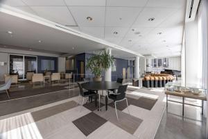 a dining room with a black table and chairs at Hotelvetro Iowa City, Tapestry Collection By Hilton in Iowa City
