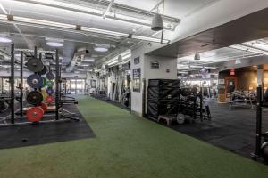 a gym with lots of equipment and a green carpet at Hotelvetro Iowa City, Tapestry Collection By Hilton in Iowa City