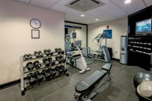 a gym with exercise equipment and a clock on the wall at Hampton Inn & Suites Montgomery-Downtown in Montgomery